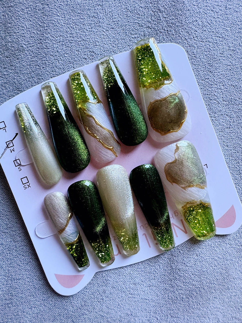 Emerald Pool Hand Drawn Elaborate Satin Gold Outline Emerald Cat Eye Flowing Sand Nail Art